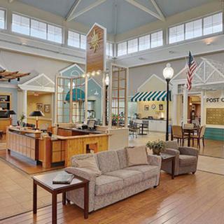 A spacious and well-lit reception area with modern seating and architectural details.