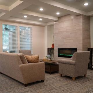 A modern living room with comfortable seating and a cozy fireplace.