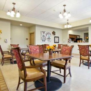 A well-lit dining area with neatly arranged tables and chairs, adorned with decorative elements.