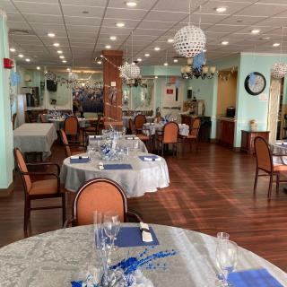 A well-decorated dining area in a restaurant with neatly arranged tables and chairs.