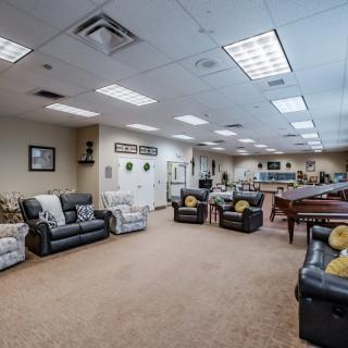 A spacious lounge area with comfortable seating and bright lighting.
