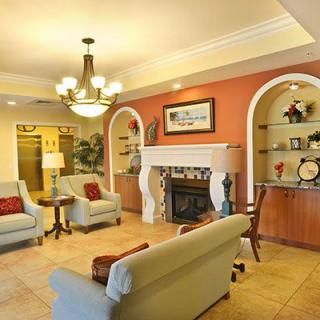 A cozy living room featuring a fireplace, comfortable seating, and elegant decor.