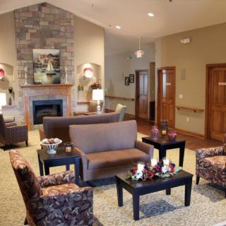 A cozy living room with a fireplace and comfortable seating arrangement.