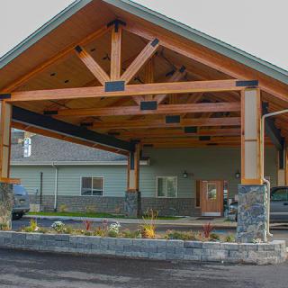 A modern building entrance with a wooden covered entryway.