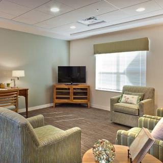 A cozy living room with modern furnishings and a television.