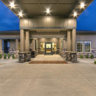 A well-lit building entrance in the evening.
