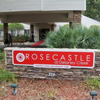 Entrance sign for Rosecastle of Delaney Creek with surrounding landscaping.