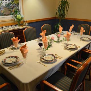 A neatly set dining table prepared for a formal dinner.
