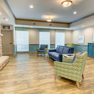 A cozy living room with modern furnishings and wooden flooring.