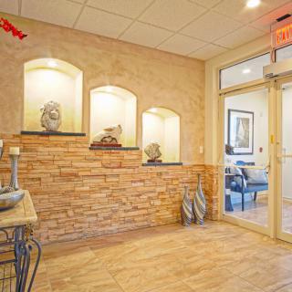 A welcoming office lobby with decorative stone walls and elegant lighting.