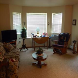 A cozy living room featuring comfortable furniture and natural light.