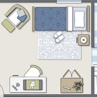 A simple bedroom floor plan with a bed, chair, desk, and rug.