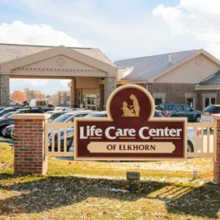 Entrance of the Life Care Center of Elkhorn with a prominent sign in the foreground.