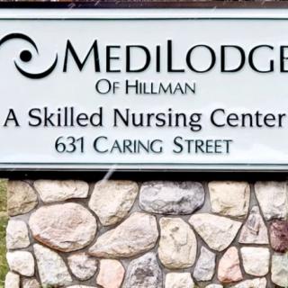 Sign for MediLodge of Hillman, a skilled nursing center located at 631 Caring Street.