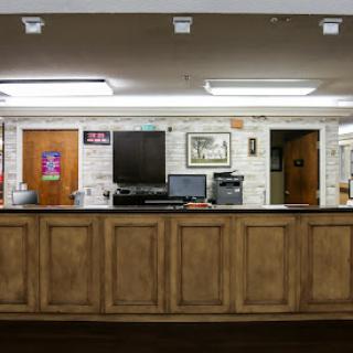 A modern reception area featuring a wooden counter and office equipment.