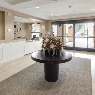 A welcoming lobby with a central table featuring a floral arrangement.
