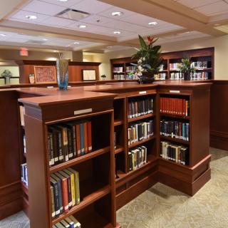 A cozy library interior with wooden bookshelves filled with books.