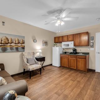 A cozy living space featuring a kitchenette and comfortable seating area.