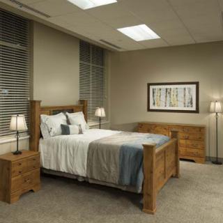 A stylish modern bedroom featuring a wooden bed frame, matching nightstands, and ambient lighting.