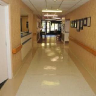 A long corridor inside a hospital with doors along the walls.