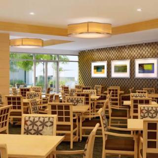 A modern restaurant dining area with neatly arranged tables and chairs.