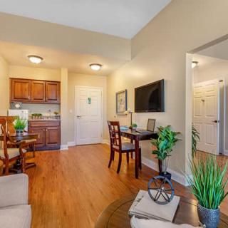 A cozy and modern living space with a small dining area, kitchenette, and stylish decor.