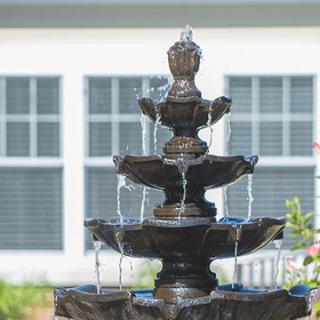 A multi-tiered outdoor fountain with water cascading down each level.