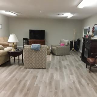A comfortable living room setup with a television, sofas, and chairs.
