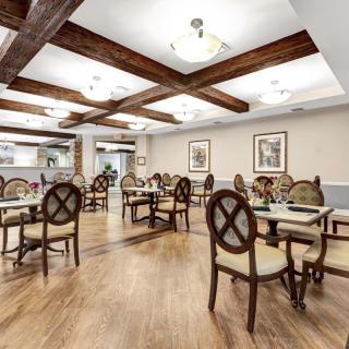 A modern dining room with wooden floors and stylish furniture.