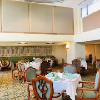 An elegant indoor dining area with neatly arranged tables and chairs.
