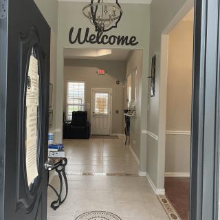 A welcoming home entrance with a decorative 'Welcome' sign.