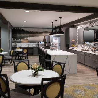 A modern kitchen and dining area with stylish tables, chairs, and contemporary decor.