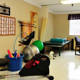 A physical therapy room equipped with exercise tools and equipment.