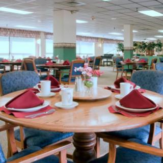 A well-arranged dining table in a spacious restaurant interior.