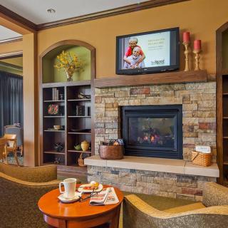 A cozy living room with a fireplace, television, and comfortable seating.