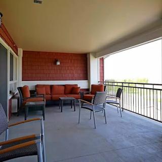 A spacious balcony featuring comfortable outdoor seating, perfect for enjoying the scenic views.