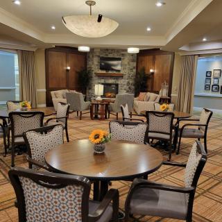 A cozy living room with multiple seating areas, a fireplace, and elegant decor.