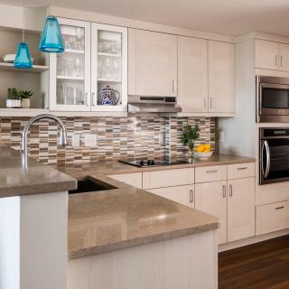 A modern kitchen interior with sleek countertops and cabinetry.