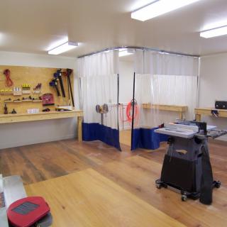 A well-organized workshop with various tools and equipment for woodworking.