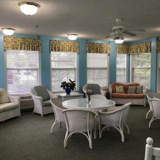 A cozy living room with comfortable seating and large windows.