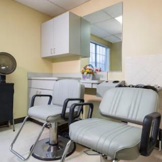 A tidy and modern hair salon interior with seating and a welcoming atmosphere.