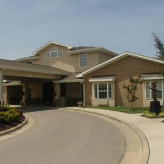 A picturesque residential home featuring a welcoming entrance and landscaped surroundings.
