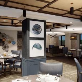 A modern restaurant interior featuring elegant dining setups and artistic decor.