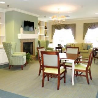 A cozy living room with comfortable seating, a fireplace, and a television.