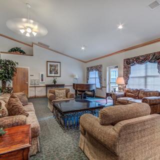 A spacious living room with comfortable seating and elegant decor.
