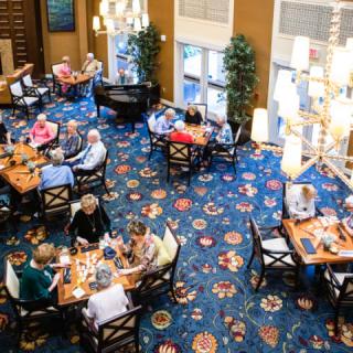 A bustling restaurant dining area with people enjoying their meals.
