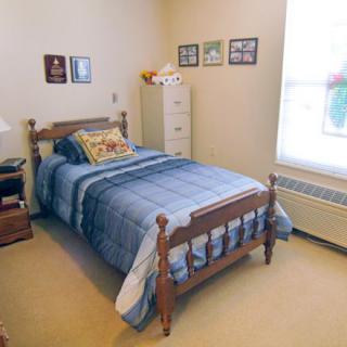 A cozy bedroom with a single bed and warm decor.