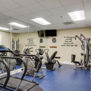 An indoor gym with various fitness equipment and exercise machines.