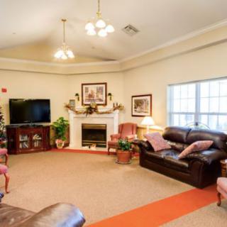 A cozy living room with sofas, a fireplace, and a television.
