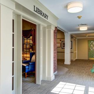 Entrance to a library with a cozy reading area visible inside.